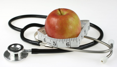 apple with measuring tape and stethoscope