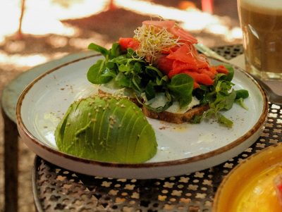open faced sandwich with avocado on a plate